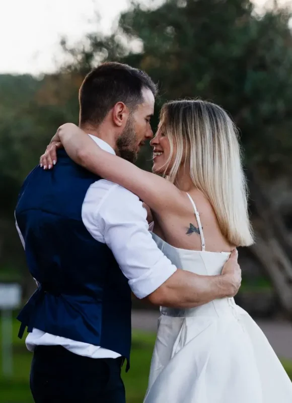 Primer plano de los novios en unos bailes de boda al aire libre, con el jardín desenfocado al fondo.